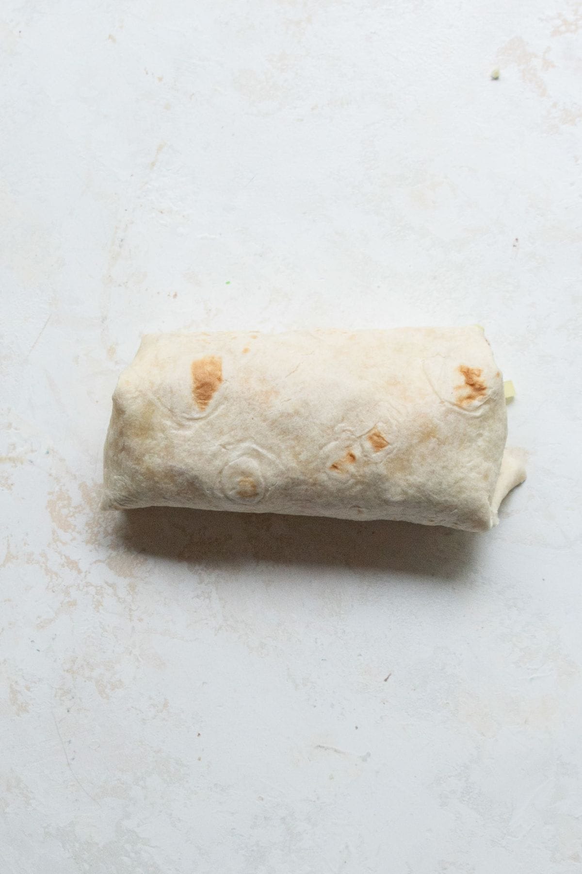 Fully wrapped buffalo chicken Caesar wrap ready to serve.