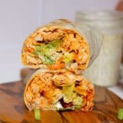 Healthy and high protein buffalo chicken Caesar wraps with homemade Greek yogurt Caesar dressing, avocado, and lettuce.