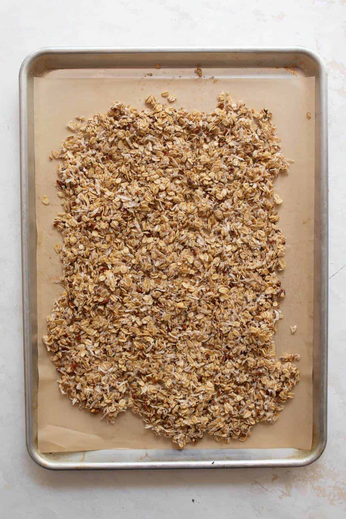 unbaked coconut granola mixture on baking sheet