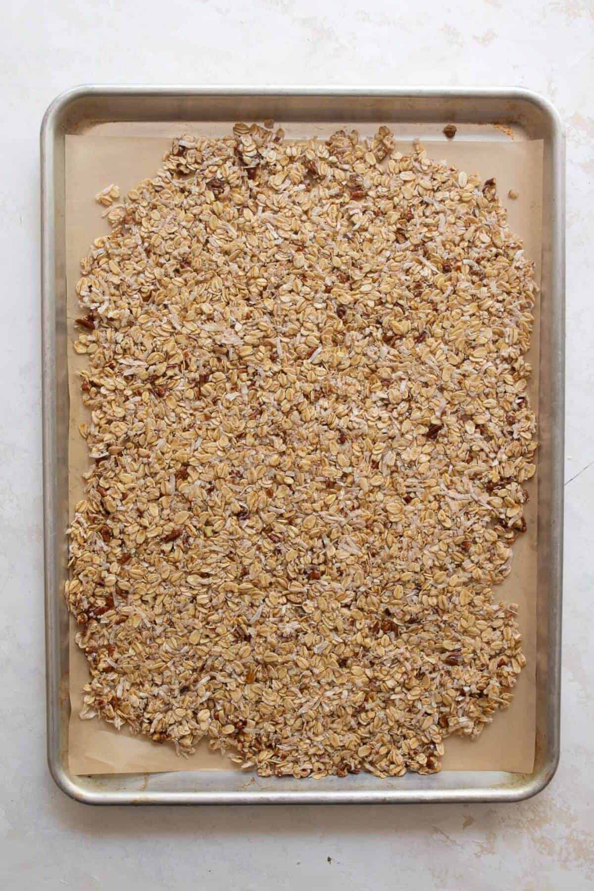 coconut granola before baking on a cookie sheet