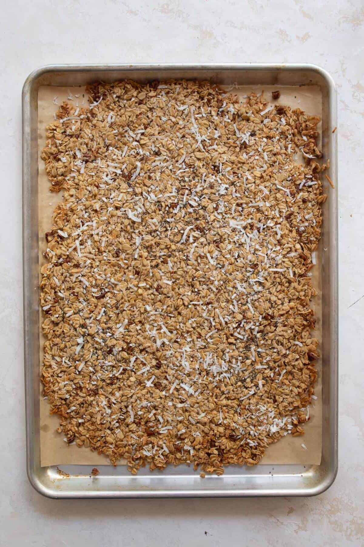crisp coconut granola after baking on a cookie sheet
