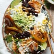 Healthy chicken fajita bowl with blackened chicken, cilantro lime rice, black beans, corn, and homemade guacamole.