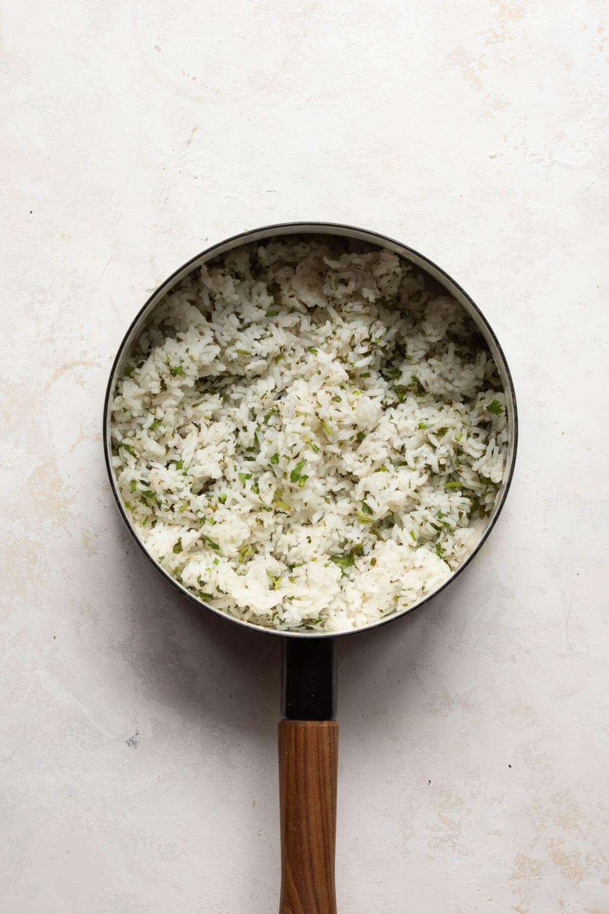 Fluffy cilantro lime rice with fresh lime zest and cilantro for healthy chicken fajita bowls.