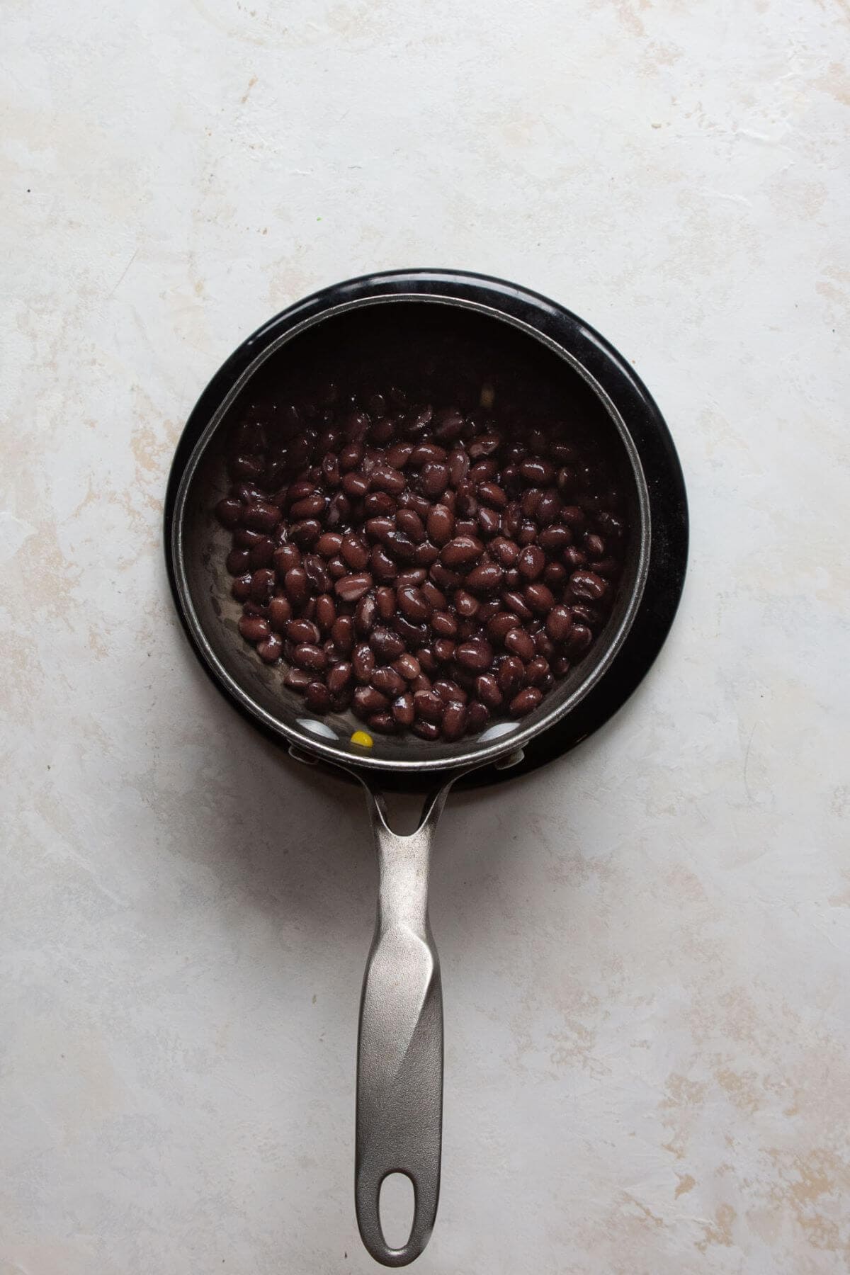 Warm black beans heated in the same cast iron pan to absorb the blackened chicken seasoning.