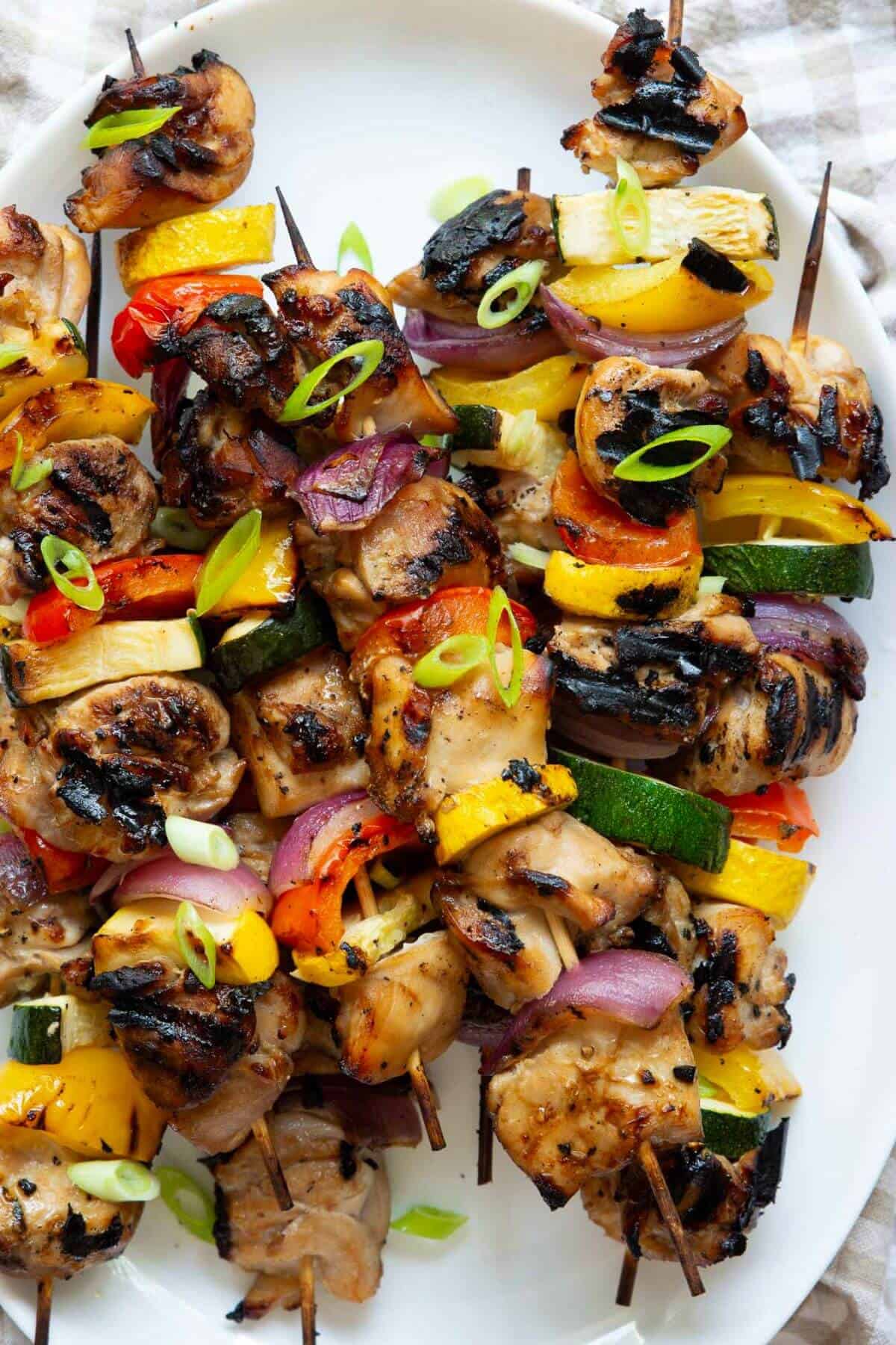 Juicy chicken thigh skewers grilled with bell peppers, zucchini, and red onion, served hot and glazed with honey soy miso sauce.