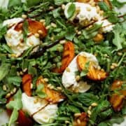 Easy Summer time grilled peach and burrata salad with fresh basil, arugula, pine nuts, and balsamic glaze