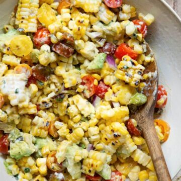 Grilled Summer Corn and Avocado Salad with cherry tomatoes and charred shishito peppers, topped with creamy ranch dressing