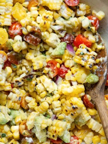 Grilled Summer Corn and Avocado Salad with cherry tomatoes and charred shishito peppers, topped with creamy ranch dressing