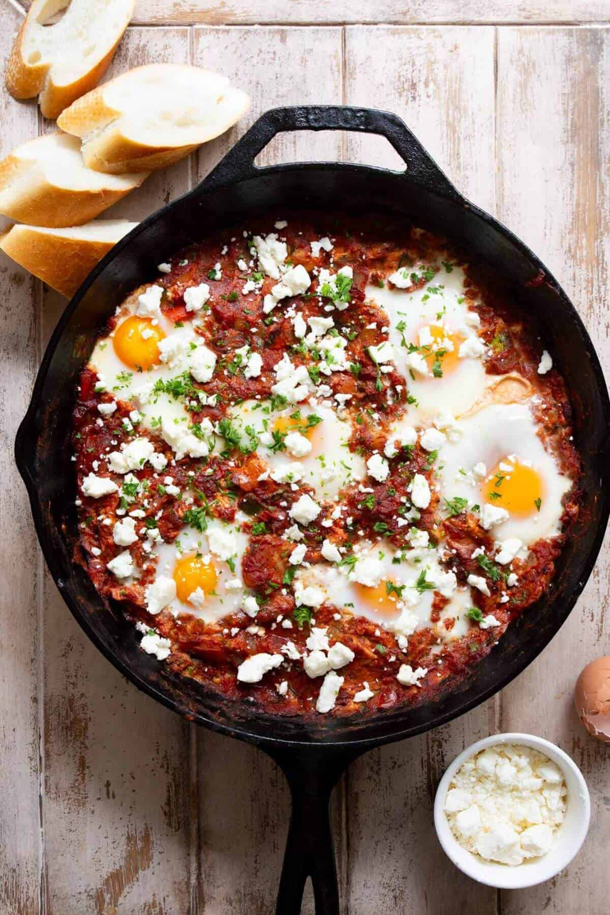 One-pan shakshuka with soft eggs and feta cheese, ready to serve