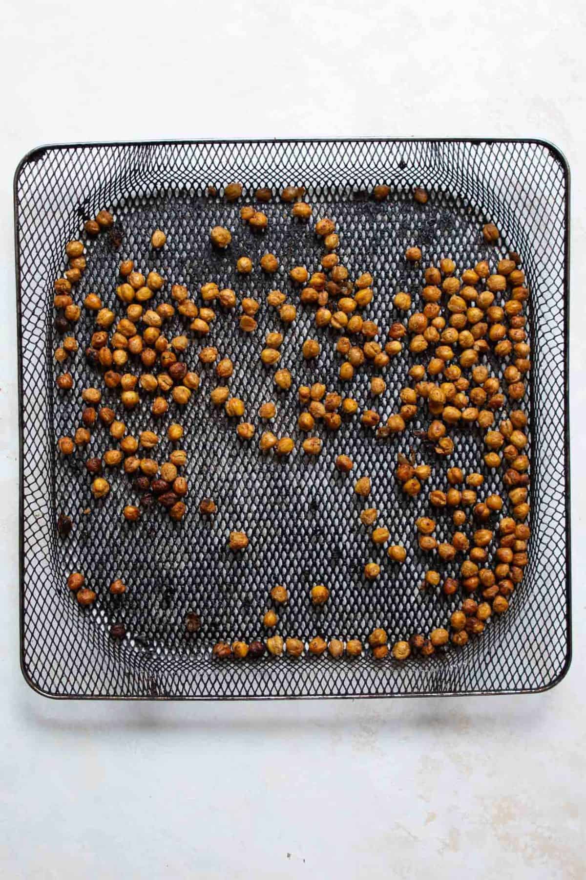crispy chickpeas in air fryer basket after cooking