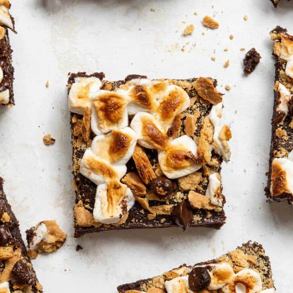 Extra fudgy healthy s'mores brownie topped with toasted marshmallows, melted chocolate, and crushed graham crackers.