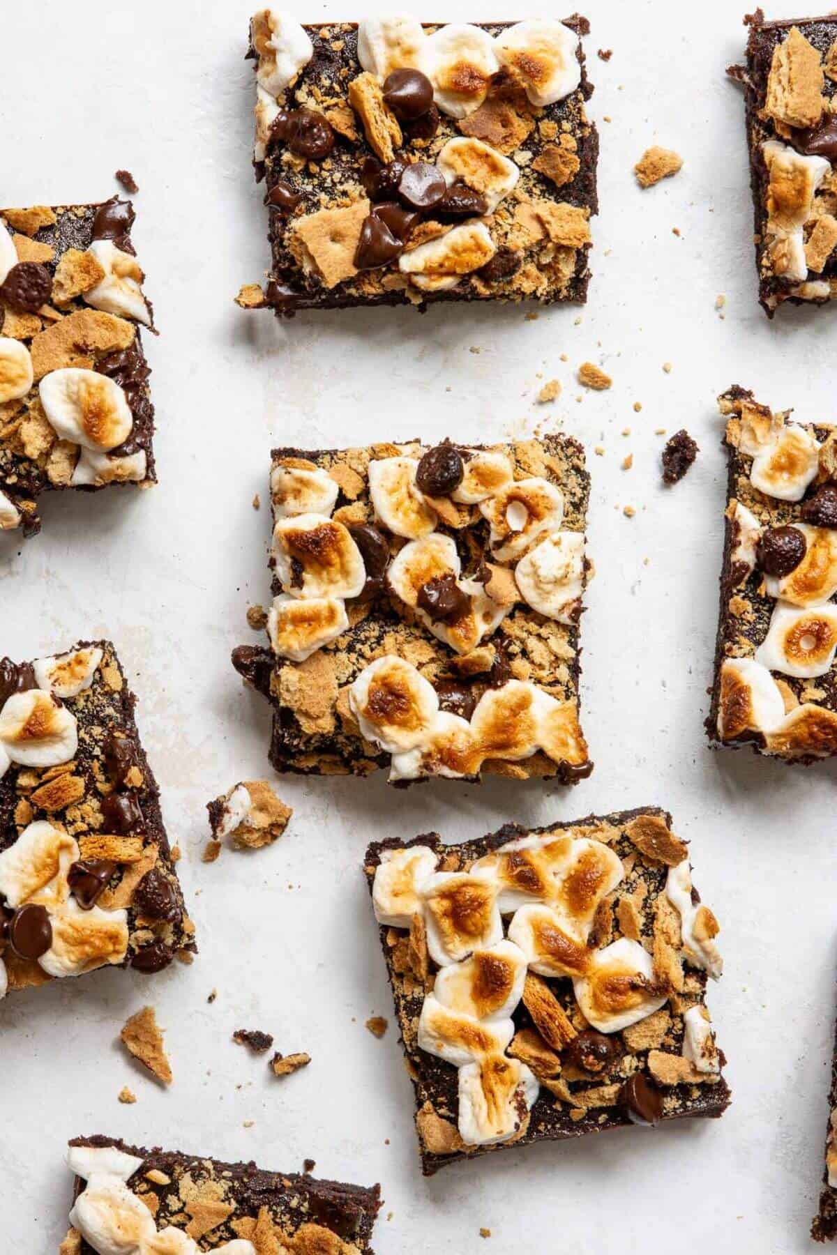 Gooey almond flour brownies with melted chocolate, golden marshmallows, and graham cracker pieces on top.