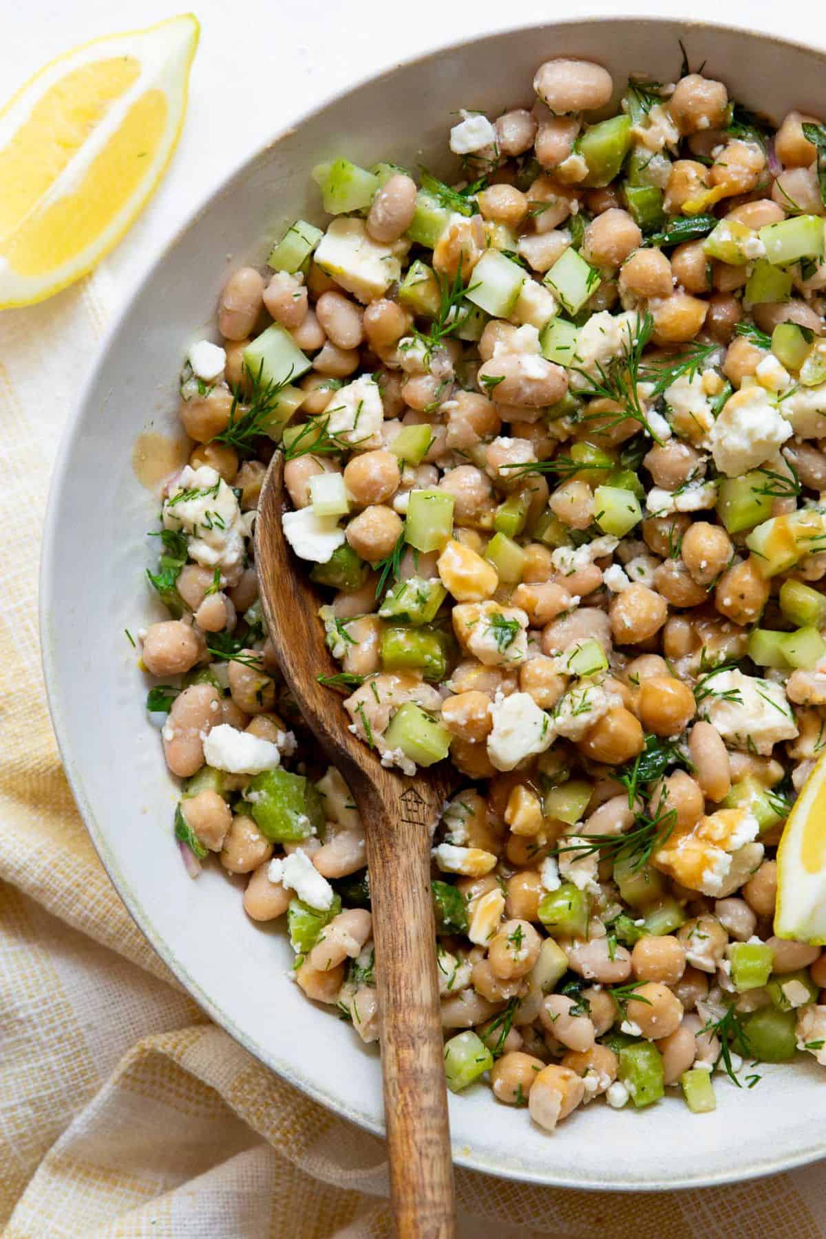 Protein packed Mediterranean dense bean salad with fresh herbs and tangy lemon dressing.