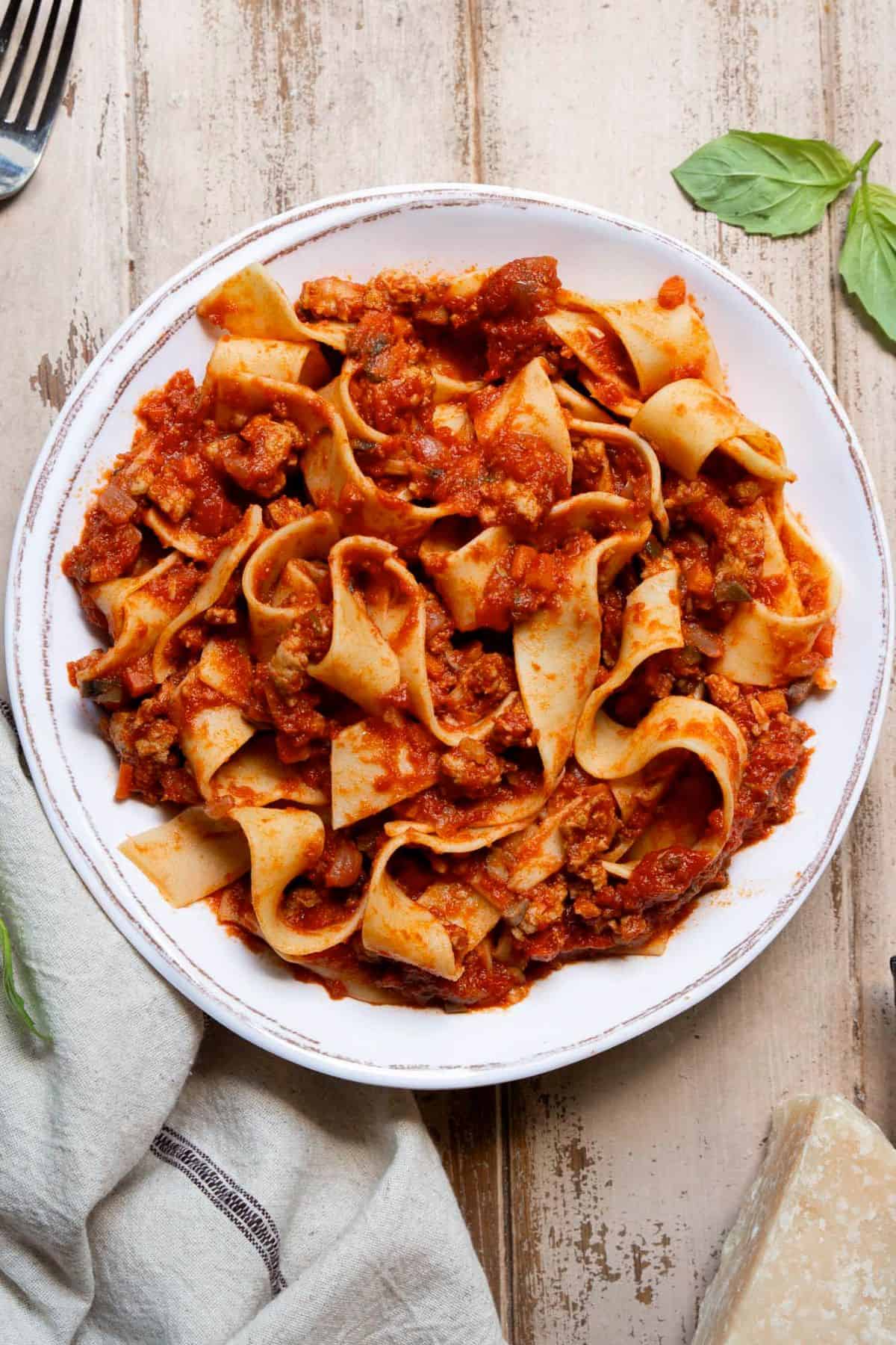 Pasta plate topped with homemade saucy chicken bolognese.