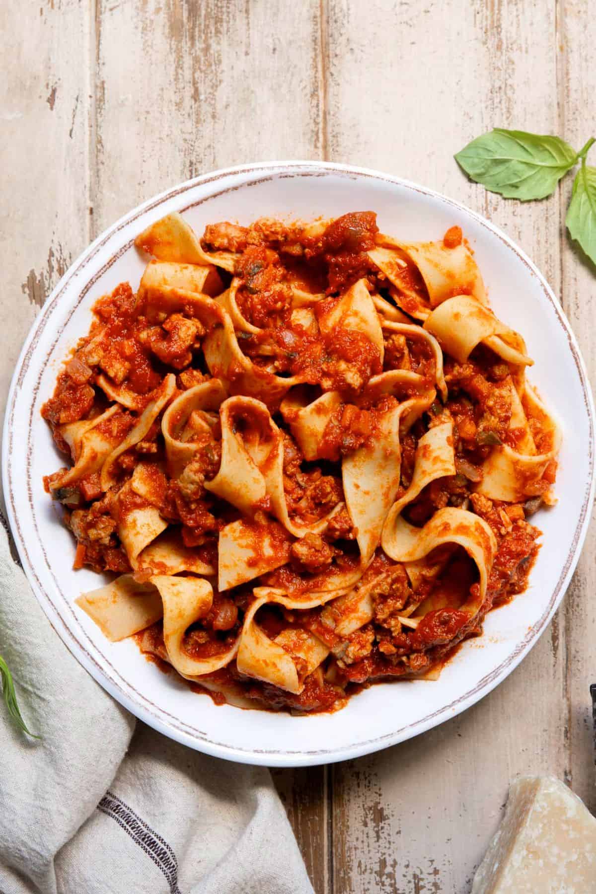 Healthy chicken bolognese served over pappardelle pasta.
