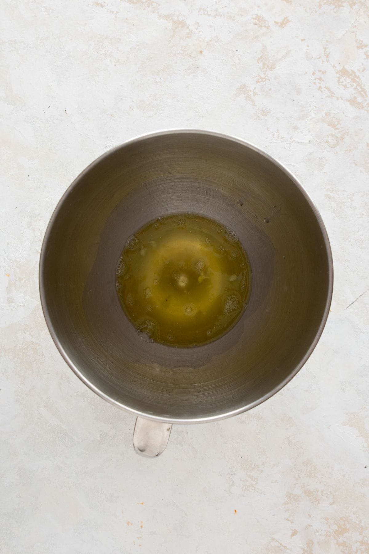 Adding fresh egg whites to a stand mixer bowl before beating.