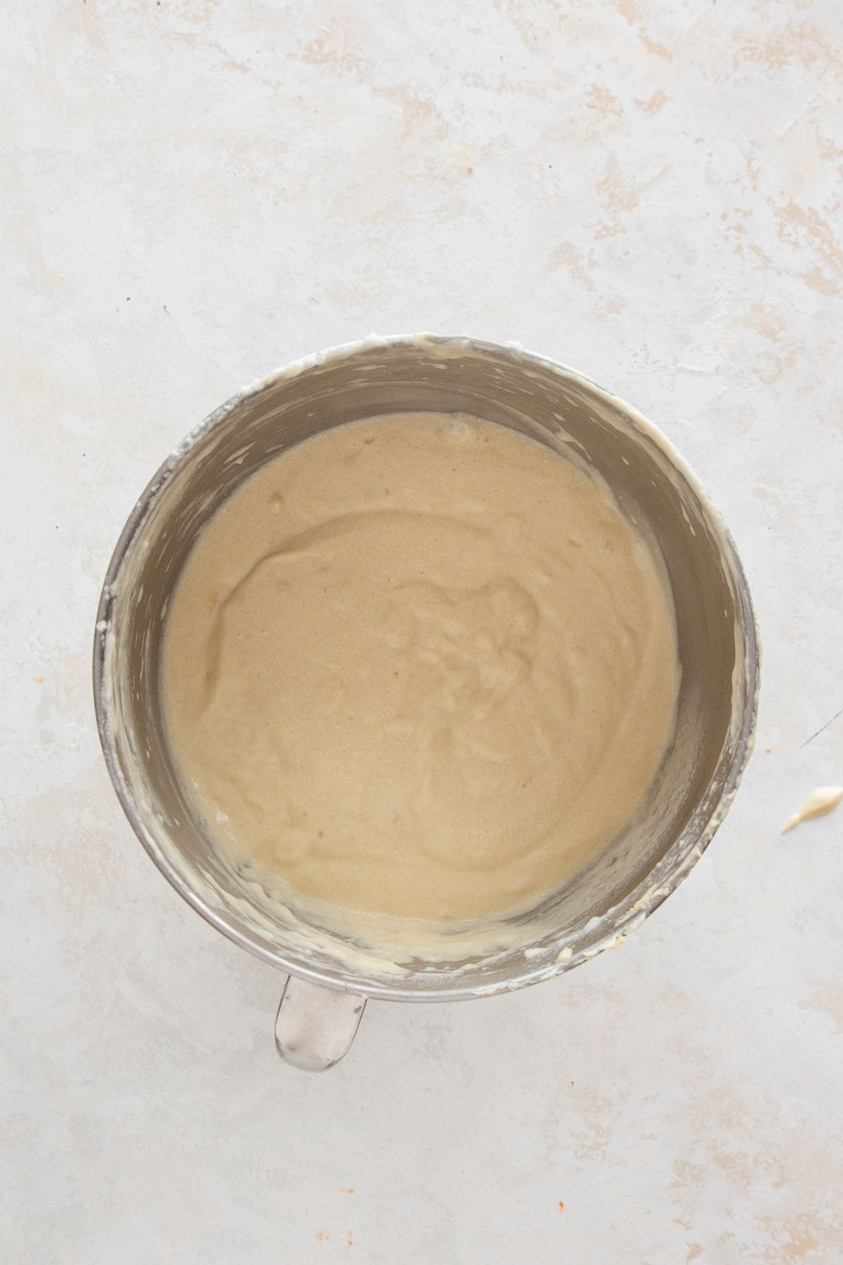 Folding whipped egg whites into the batter with a spatula to keep the cake light, airy, and fluffy.