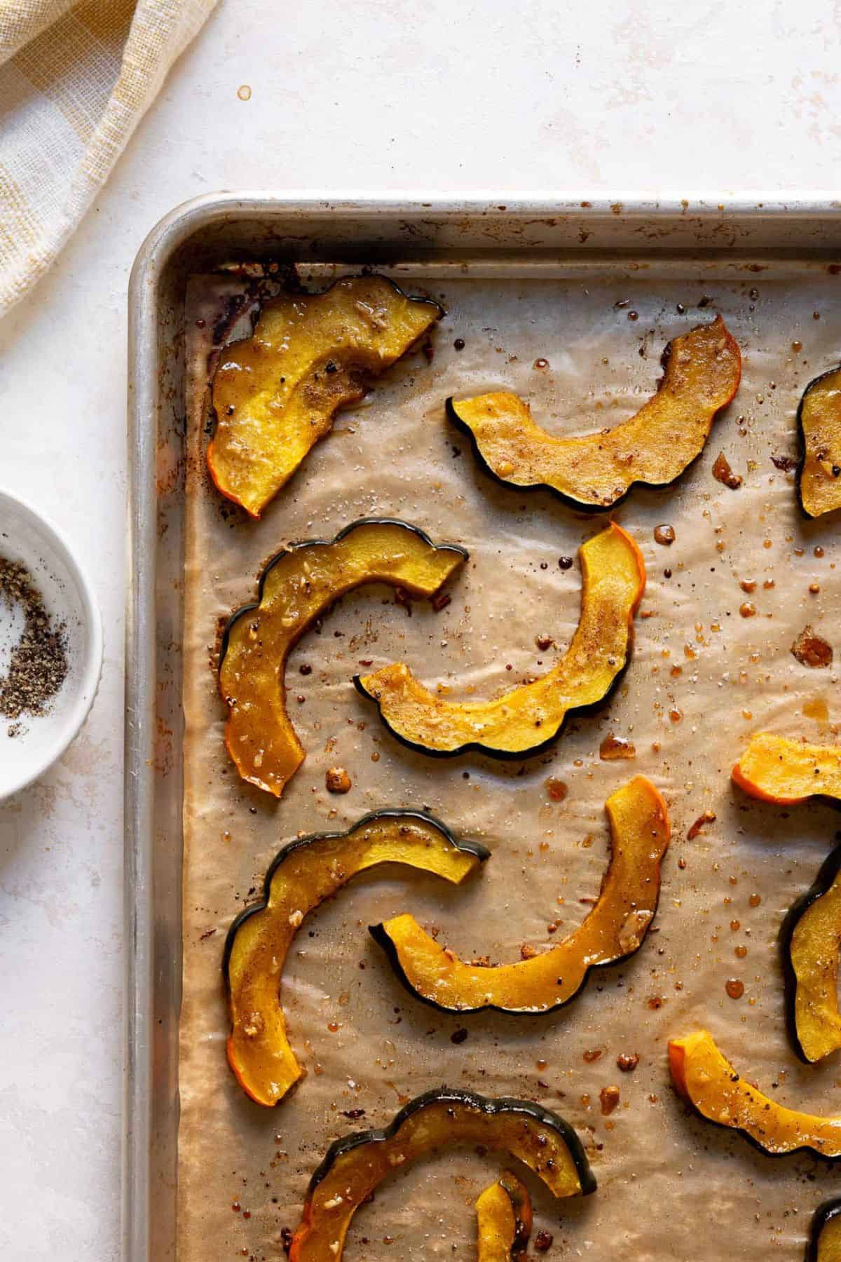 Golden maple roasted acorn squash slices with caramelized edges.