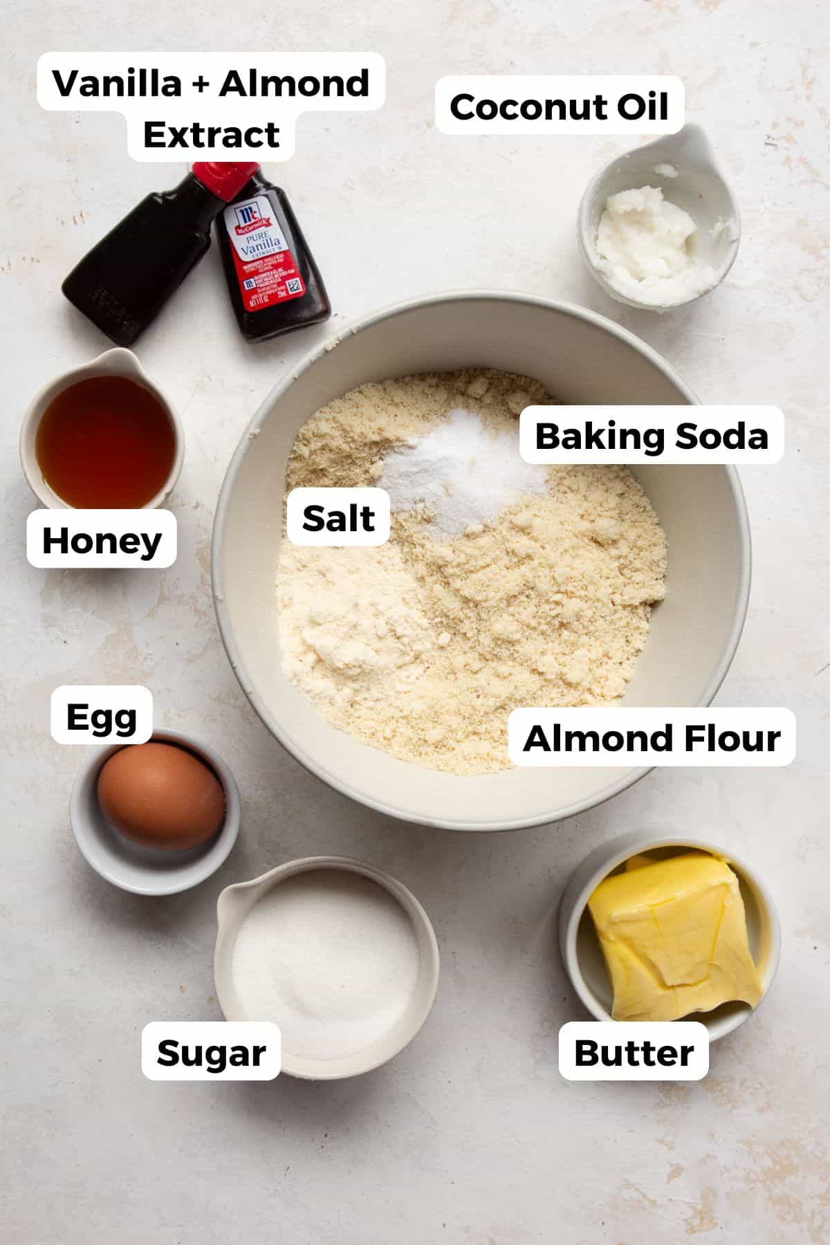 Ingredients for almond flour sugar cookies, including almond flour, coconut flour, butter, coconut oil, sugar, honey, egg, and vanilla extract.