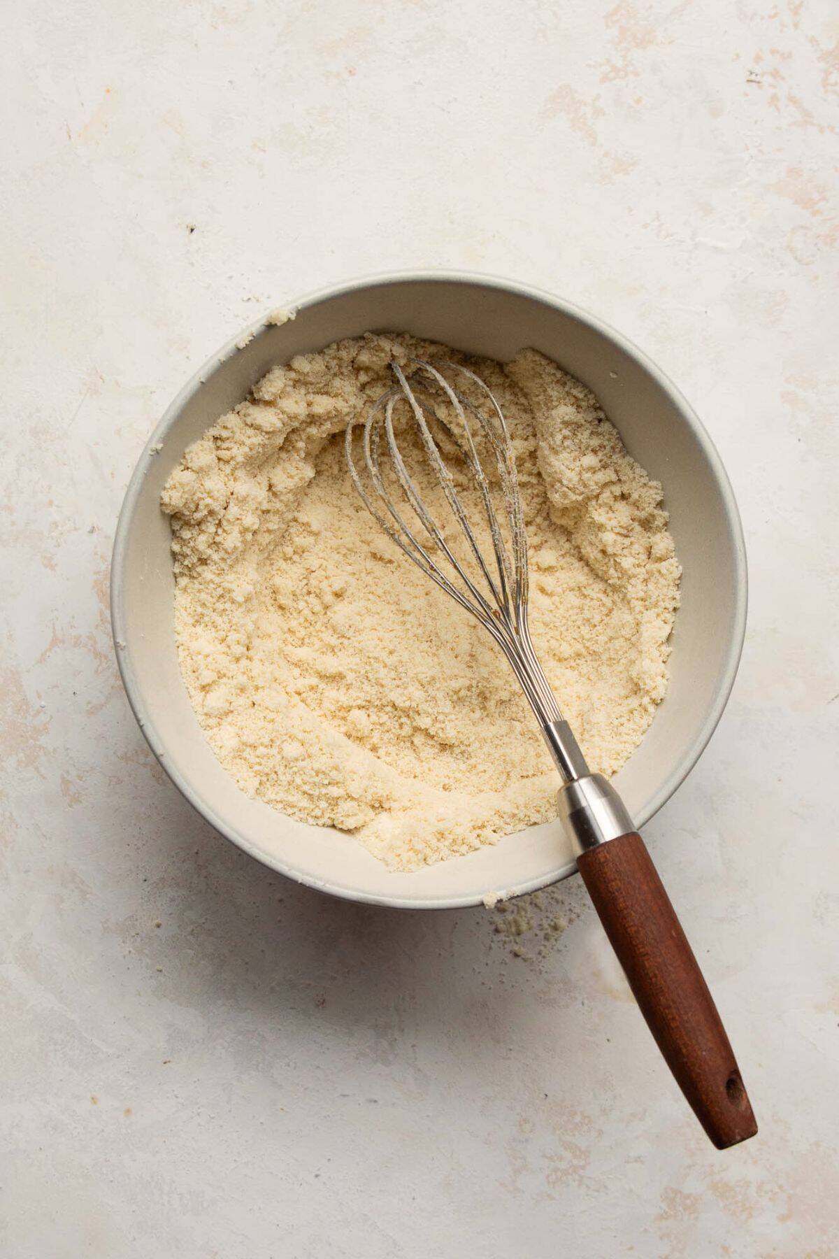 Almond flour, coconut flour, salt, and baking soda whisked together in a bowl.