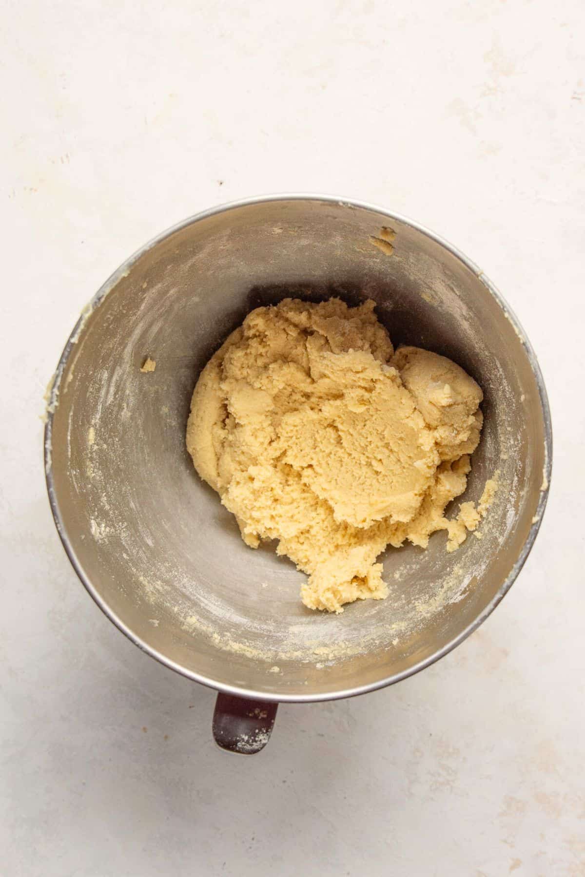 Soft almond flour cookie dough in a stand mixer bowl.