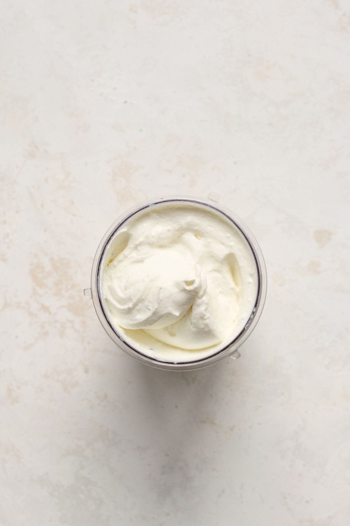 Blending cottage cheese to be smooth for the mac and cheese sauce.