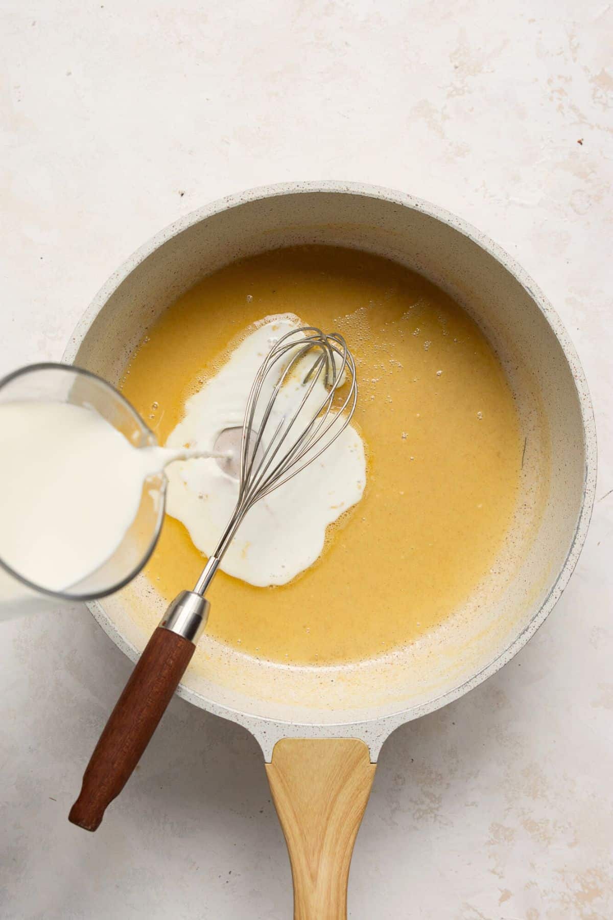 Adding in the milk to the roux.