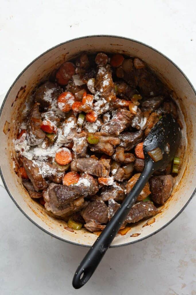 Beef and vegetables coated with flour before adding broth.