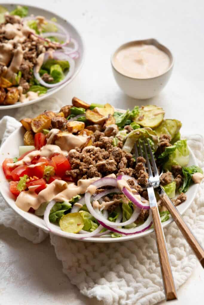 Healthy burger bowl with seasoned beef and Greek yogurt special sauce.