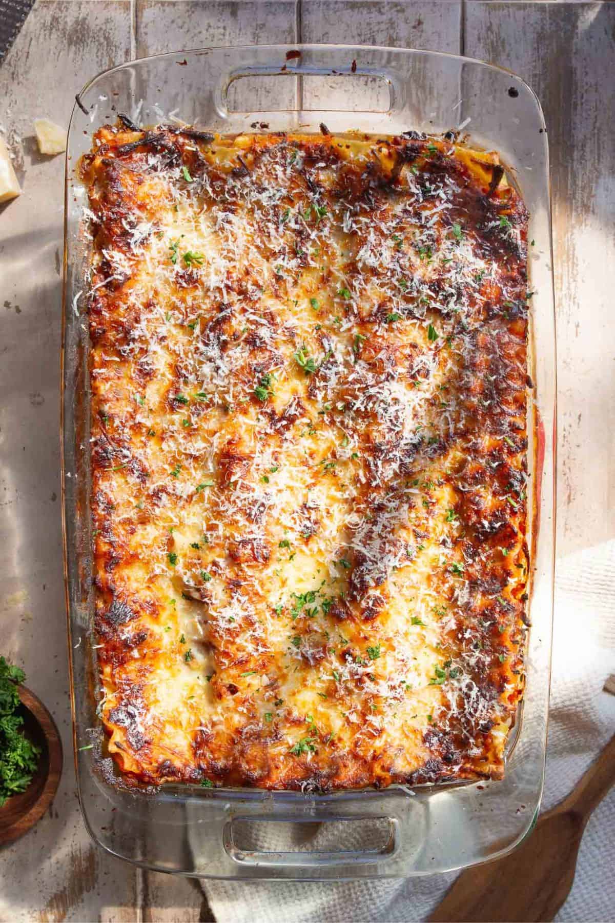 Baked cottage cheese lasagna in a glass baking dish with golden, bubbly cheese on top.