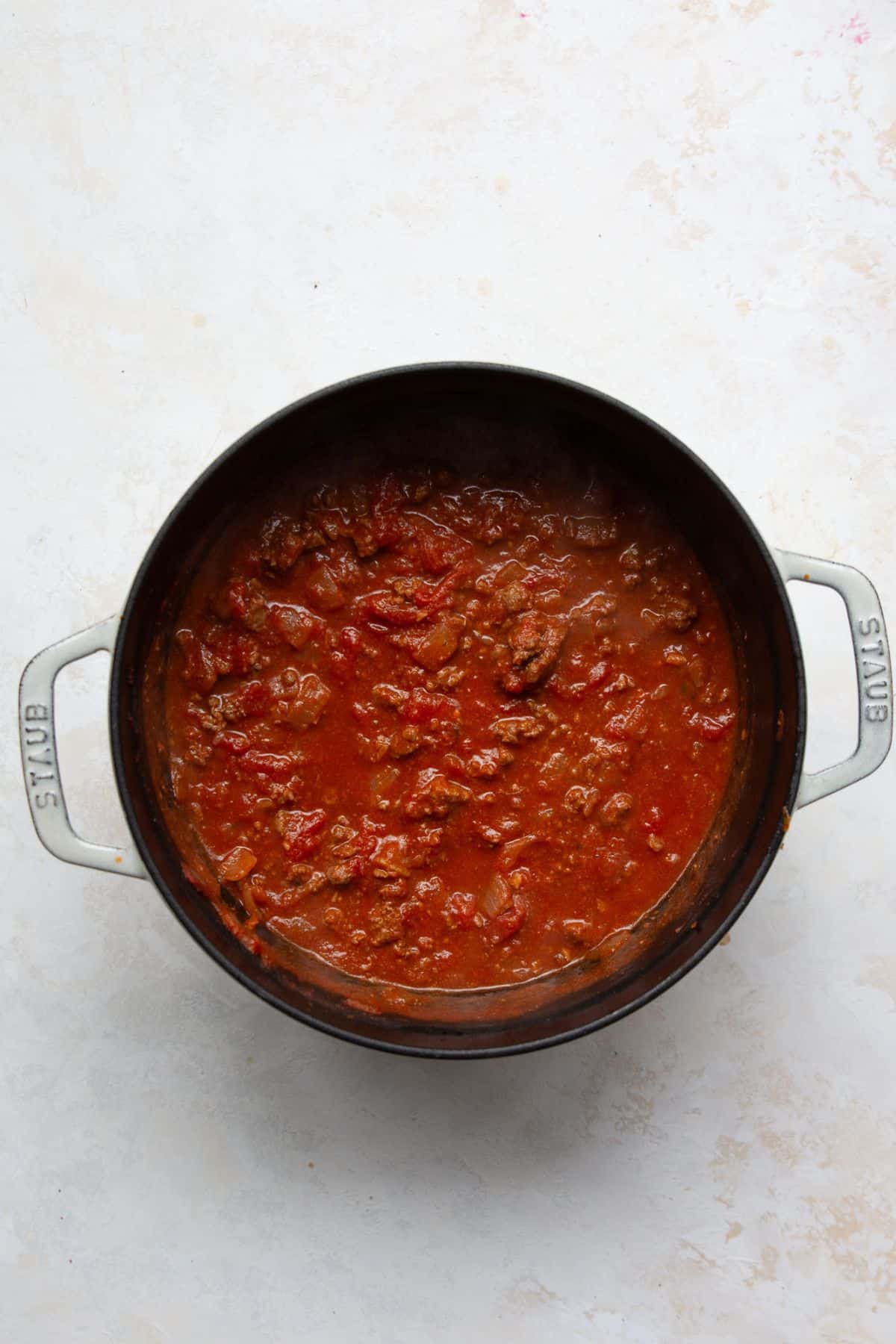 Tomato meat sauce simmering on the stove.