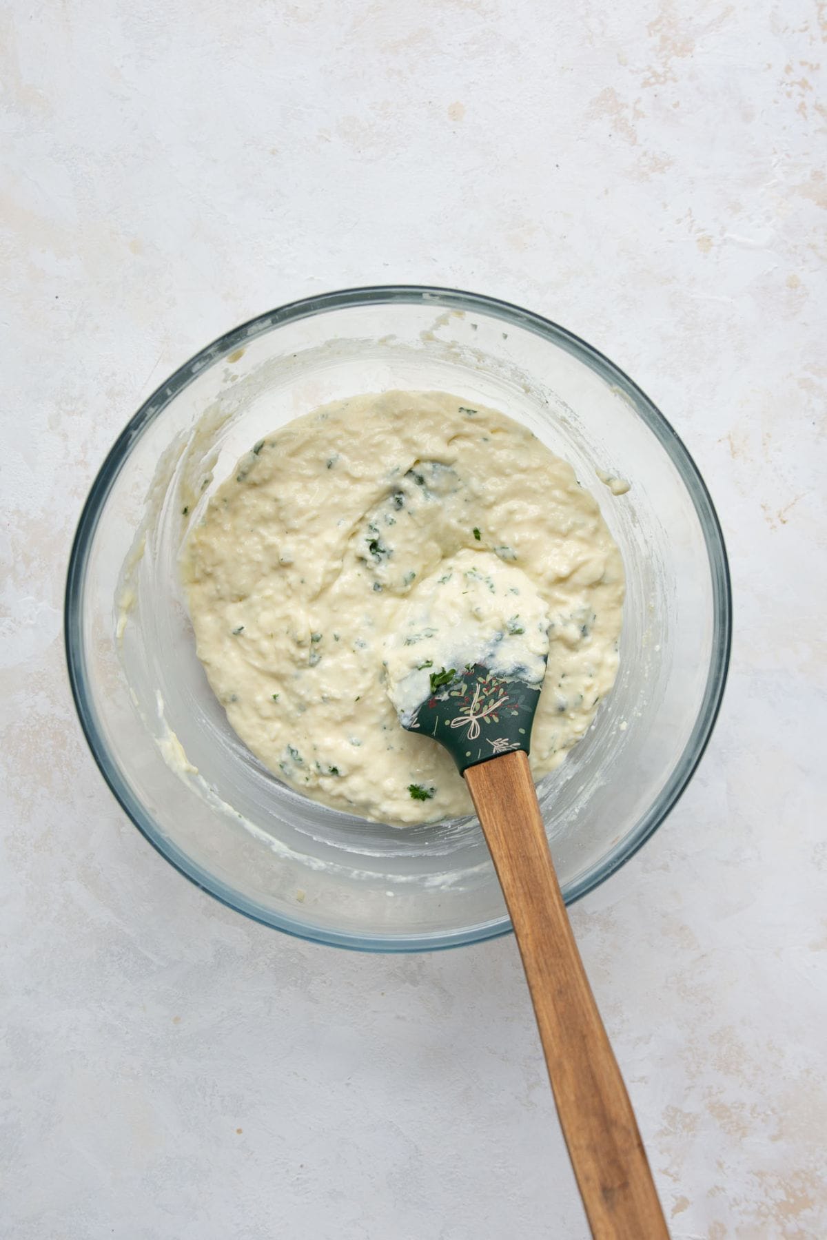 High protein lasagna filling in a bowl made with blended cottage cheese, egg, Parmesan, and parsley.