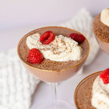 Thick and creamy high protein cottage cheese chocolate mousse with fresh raspberries.