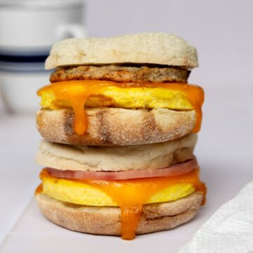 High-protein freezer breakfast sandwich with fluffy cottage cheese eggs, cheese, and chicken sausage on toasted English muffin.