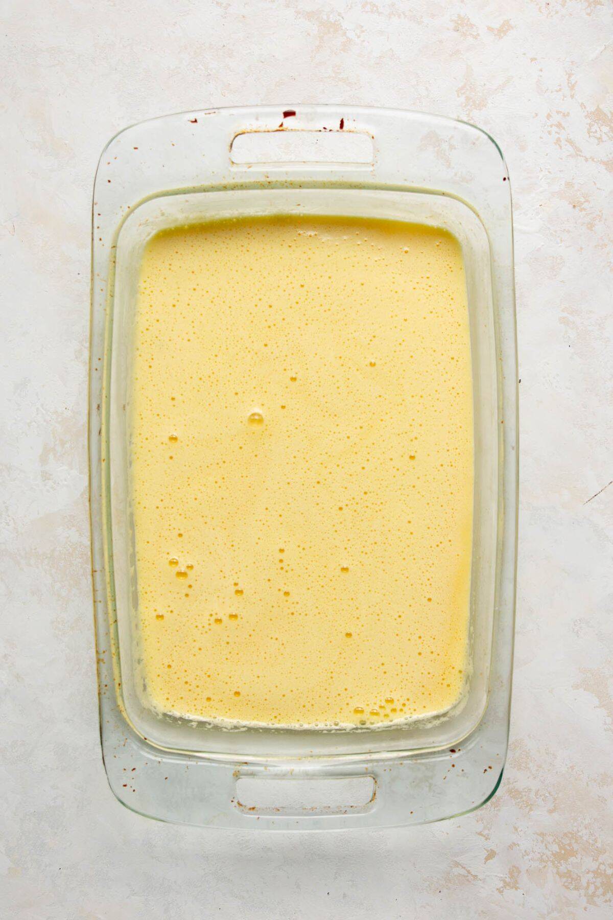 Egg and cottage cheese mixture poured into baking dish before baking.