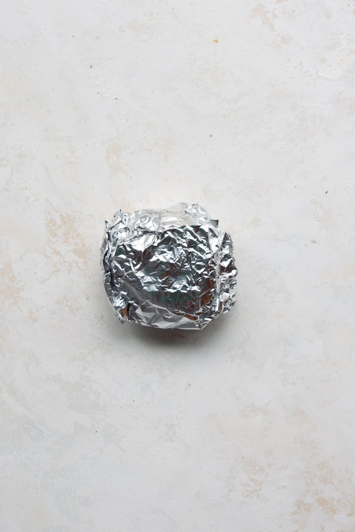 Breakfast sandwich wrapped in foil for freezer meal prep.