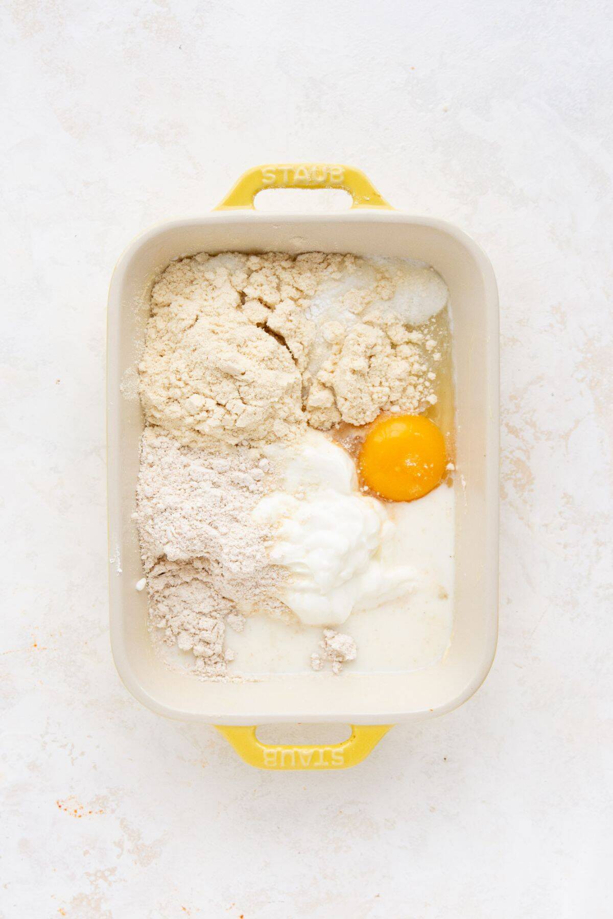 All ingredients for a protein pancake bowl in a baking dish before whisking.