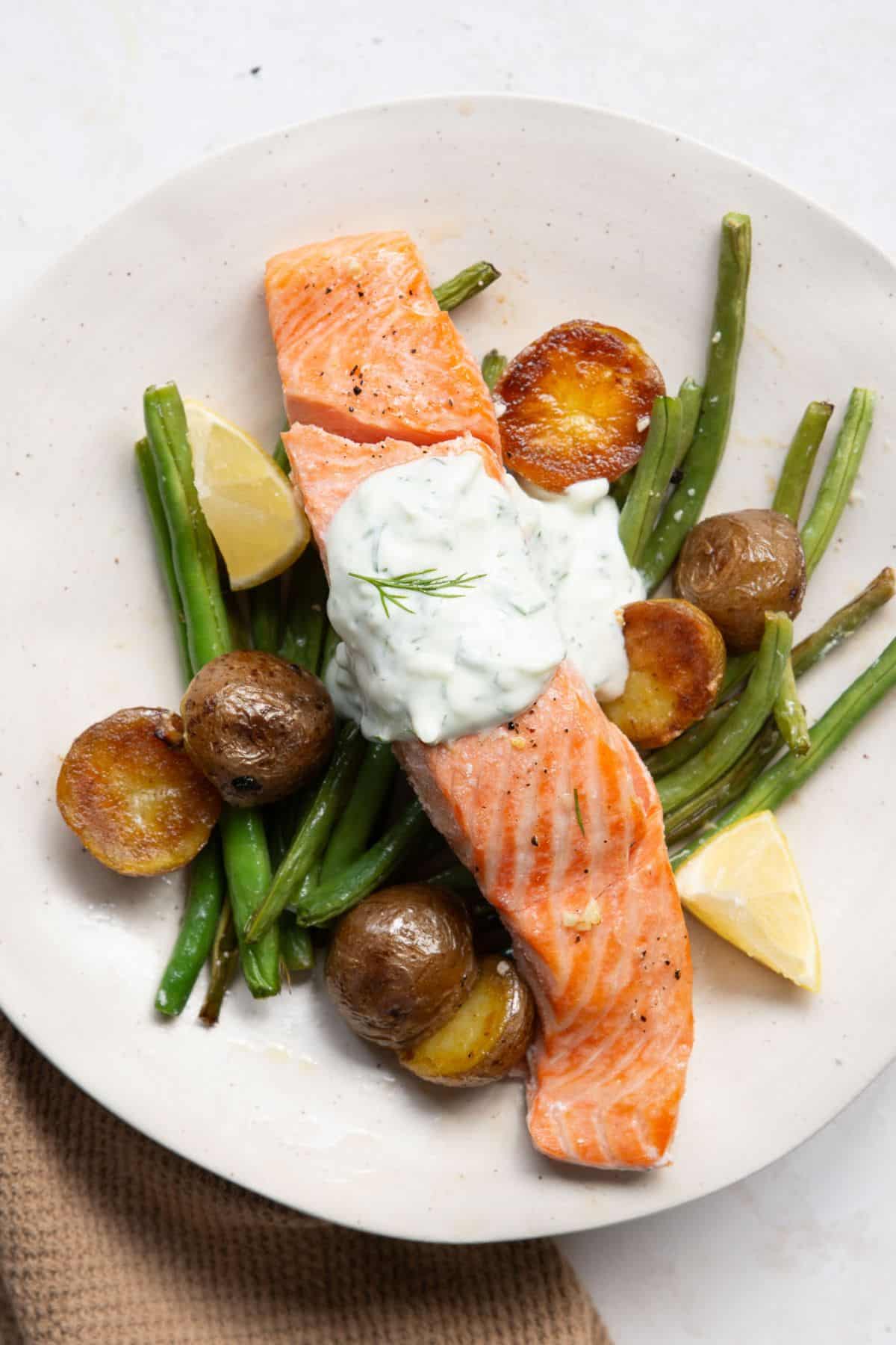 Flakey salmon served with roasted green beans, lemon garlic crispy potatoes, and served with tzatziki sauce.