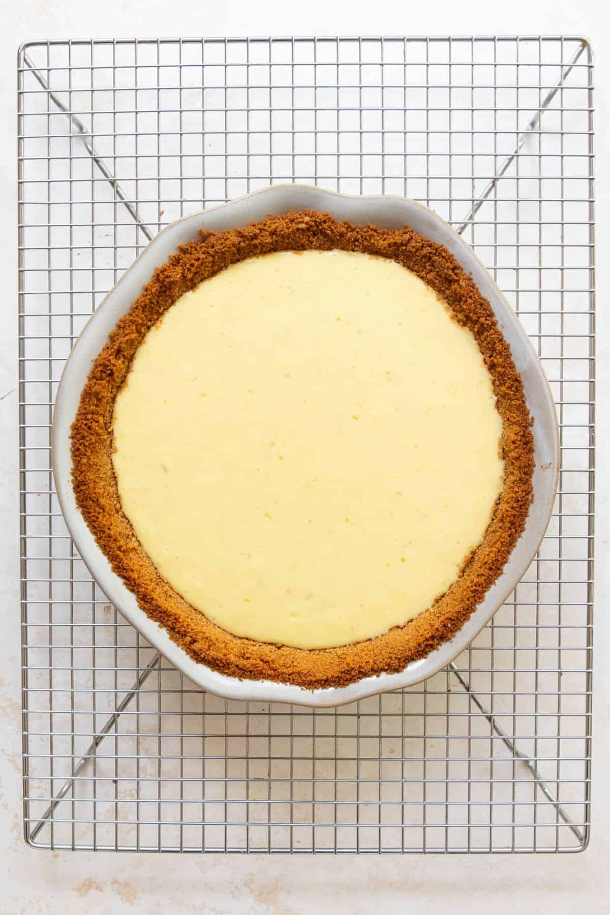 Baked gluten-free key lime pie cooling on a wire rack.