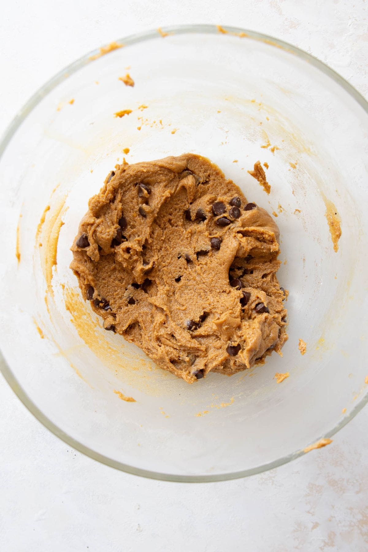 Protein cookie dough with chocolate chips folded in, resting before scooping.
