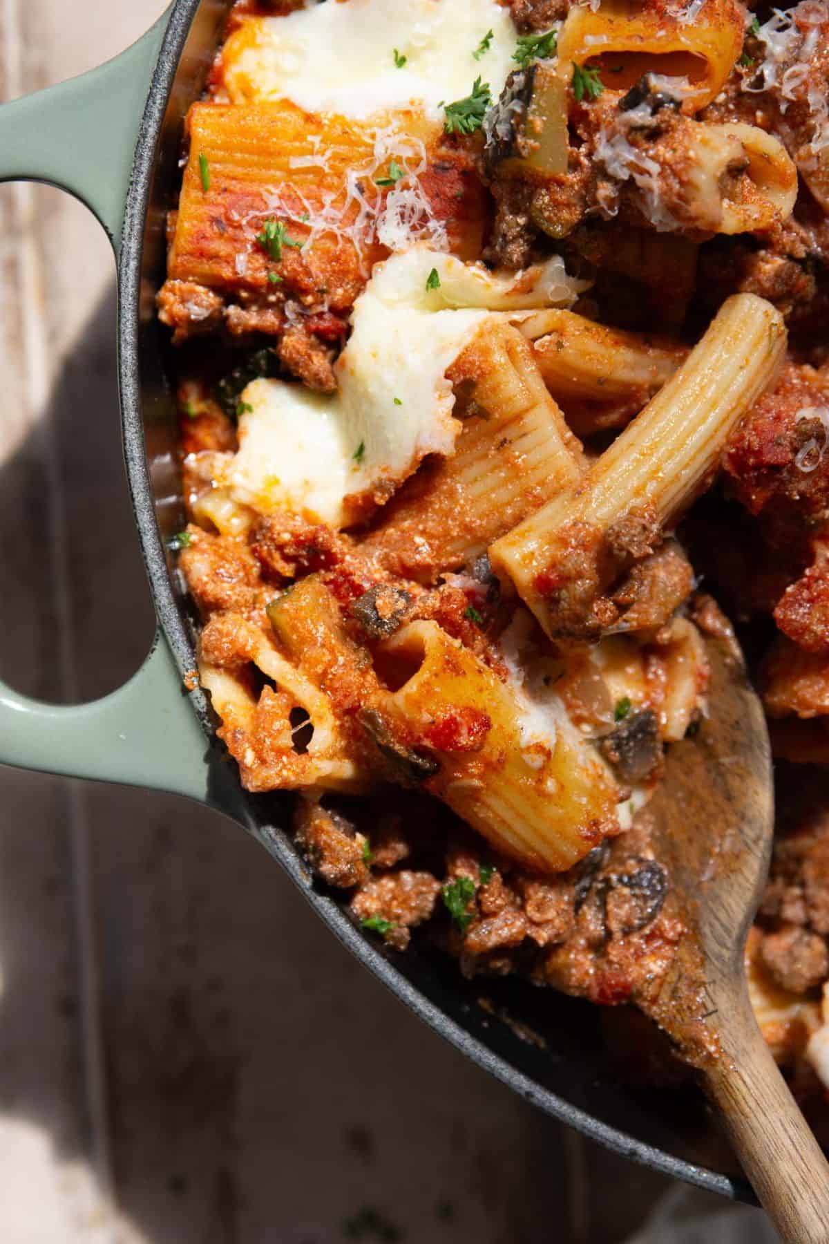 Close up of healthy baked rigatoni with cottage cheese, ground beef, and bubbly fresh mozzarella on top.