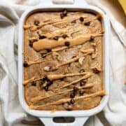 Healthy single serve banana bread, drizzled with peanut butter and topped with chocolate chips and walnuts.