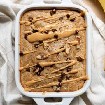 Healthy single serve banana bread, drizzled with peanut butter and topped with chocolate chips and walnuts.