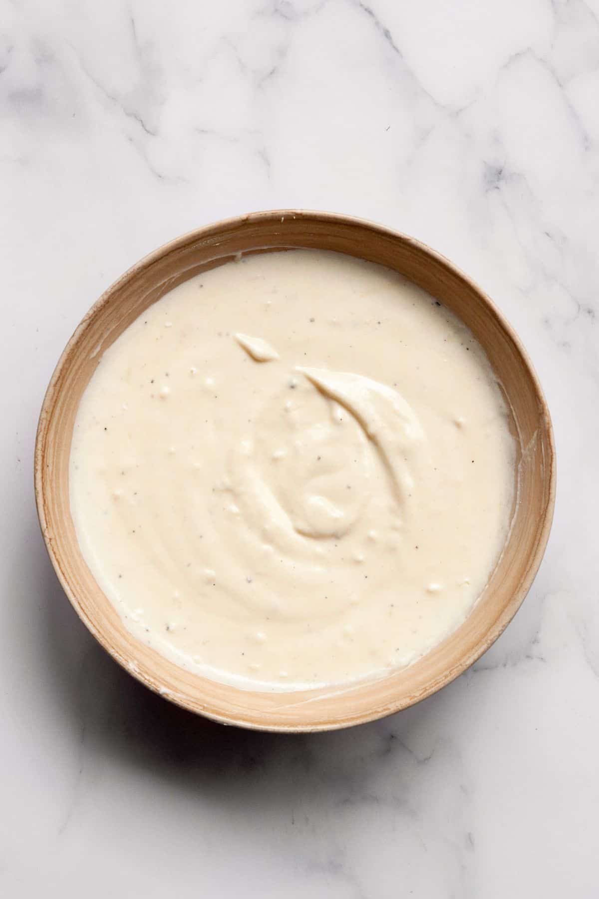 Creamy no-mayo Greek yogurt Caesar dressing whisked together.
