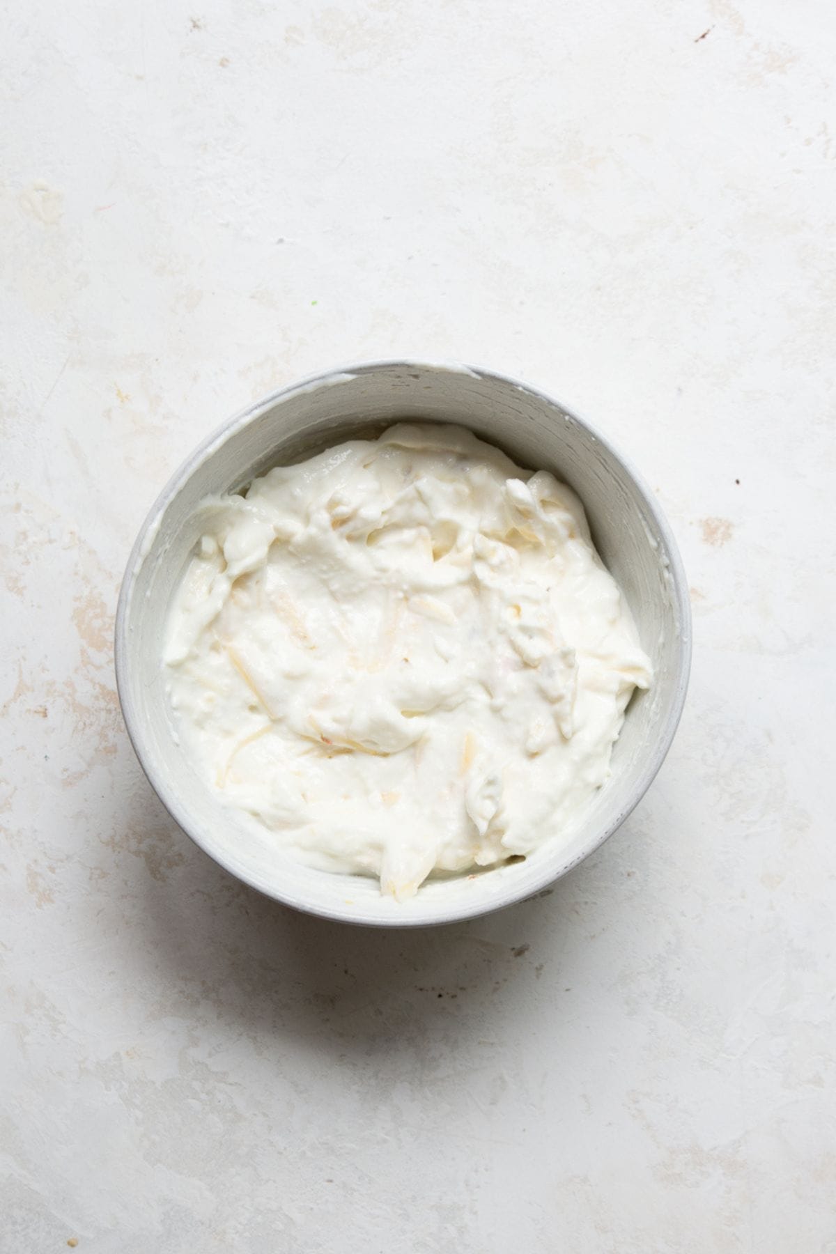 Blended cottage cheese stirred together with shredded pepper jack in a small bowl.
