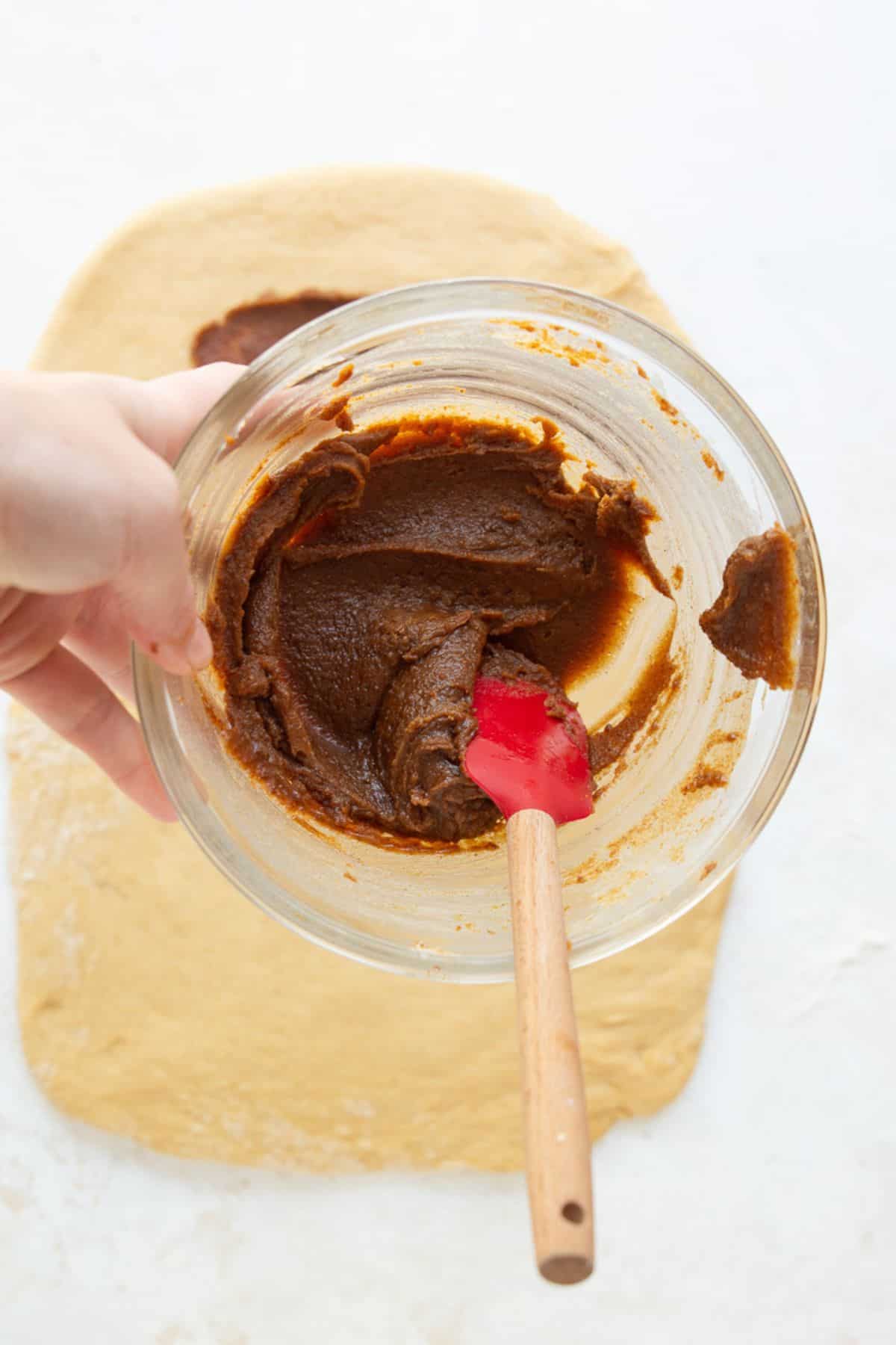 Cinnamon roll filling made with softened butter, coconut sugar, and cinnamon stirred to a smooth paste.