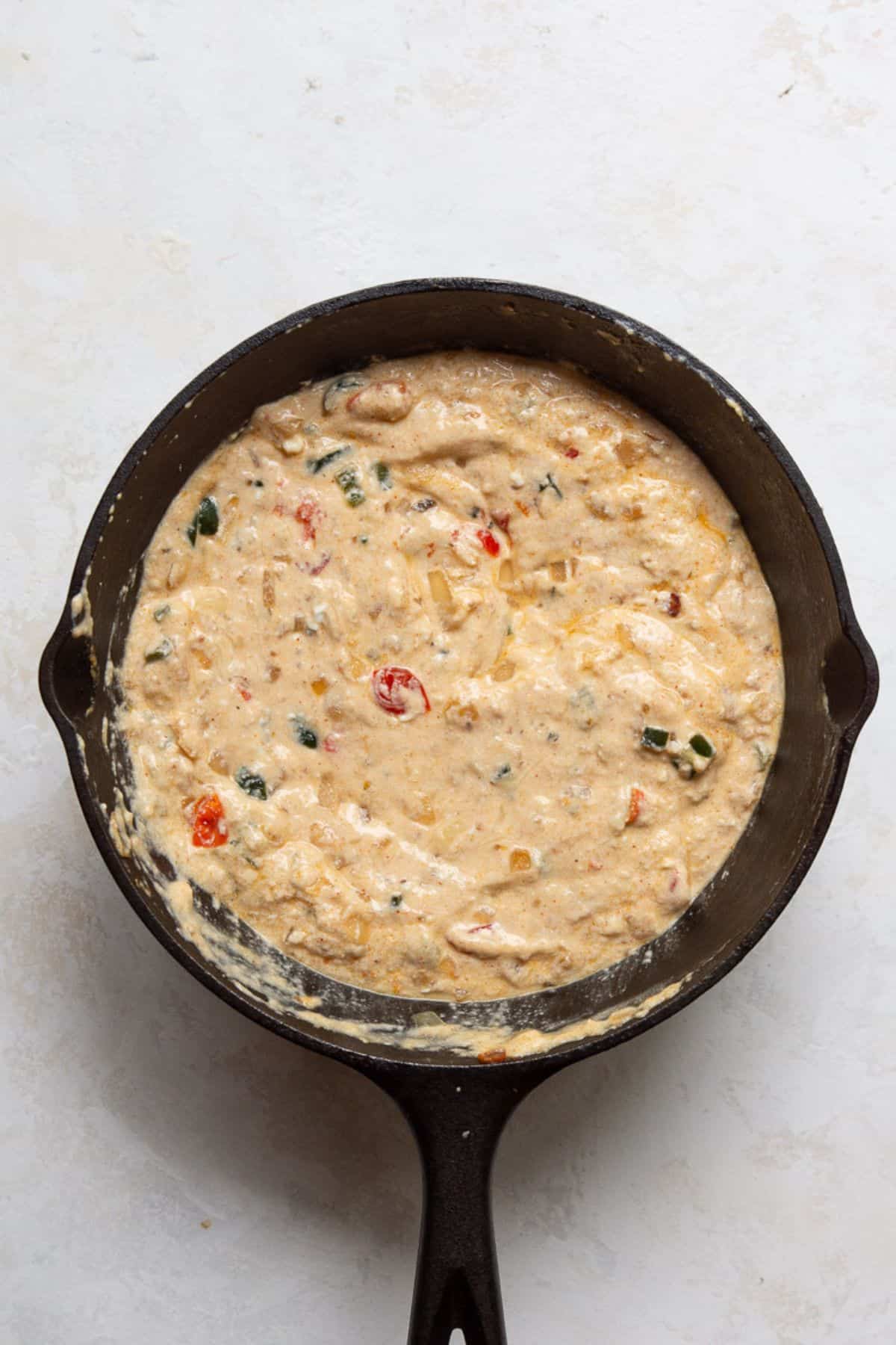 Cottage cheese queso in a cast iron skillet before the final blend.