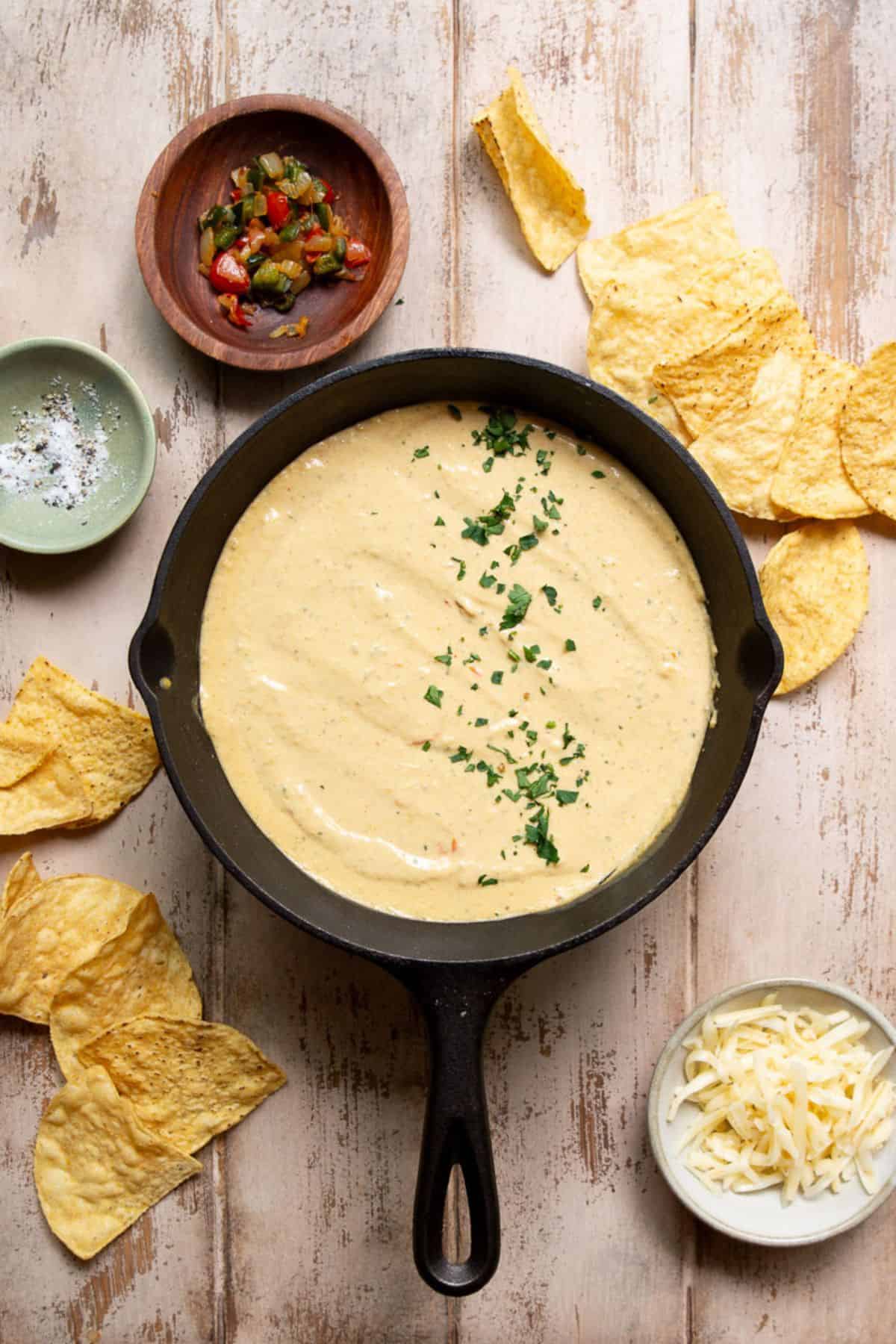 Creamy cottage cheese queso in a cast iron skillet after blending.