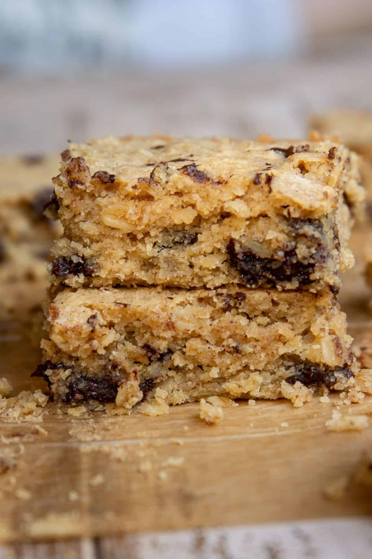 Stack of two gooey healthy chocolate chip oatmeal bars with melted chocolate chips.