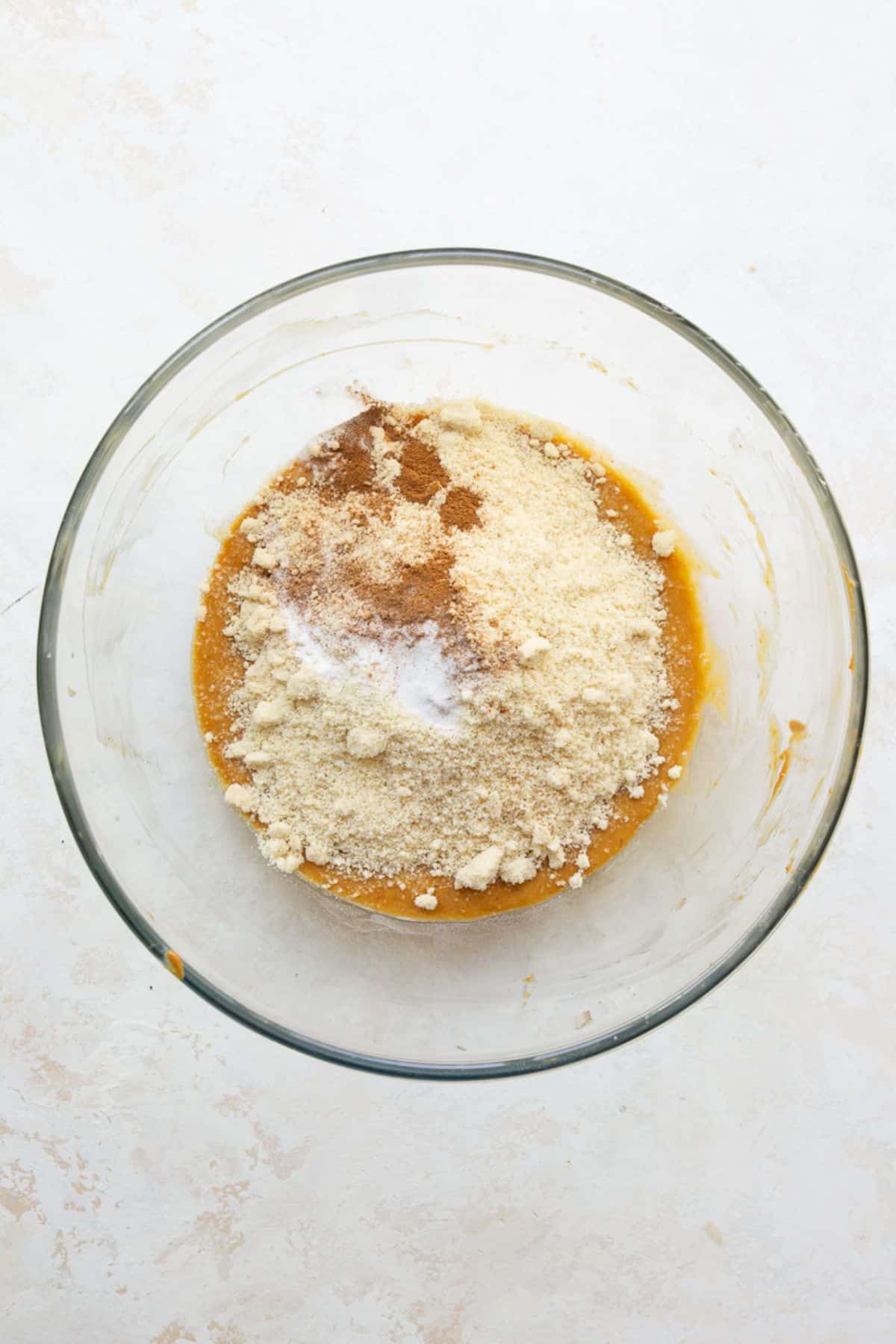 Almond flour, cinnamon and baking soda added on top of the wet muffin batter.